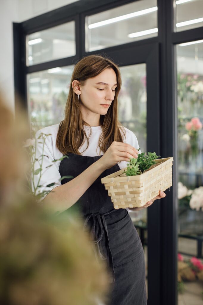 A young woman works in her flower shop. Small business concept.