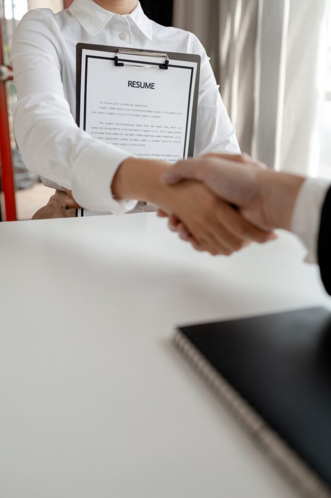 Woman candidate interview with HR manager in office, Examiner reading a resume during job interview