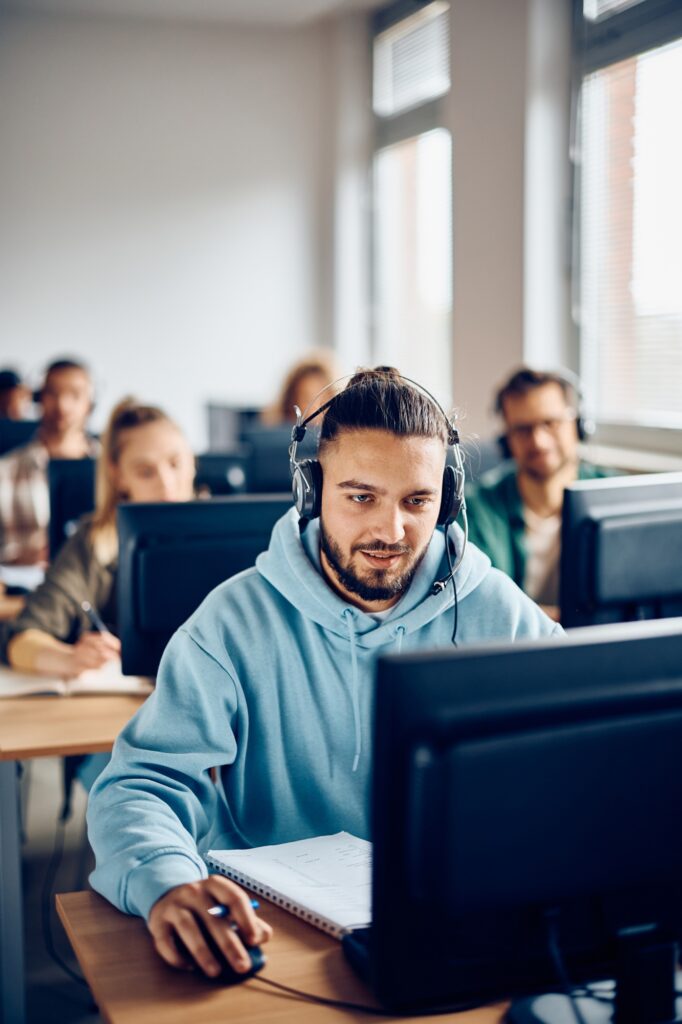 Young student e-leaning during computer class in the classroom.